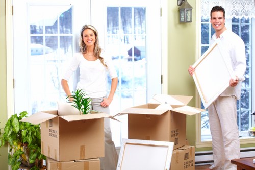 Removal team loading household furniture for a flat move